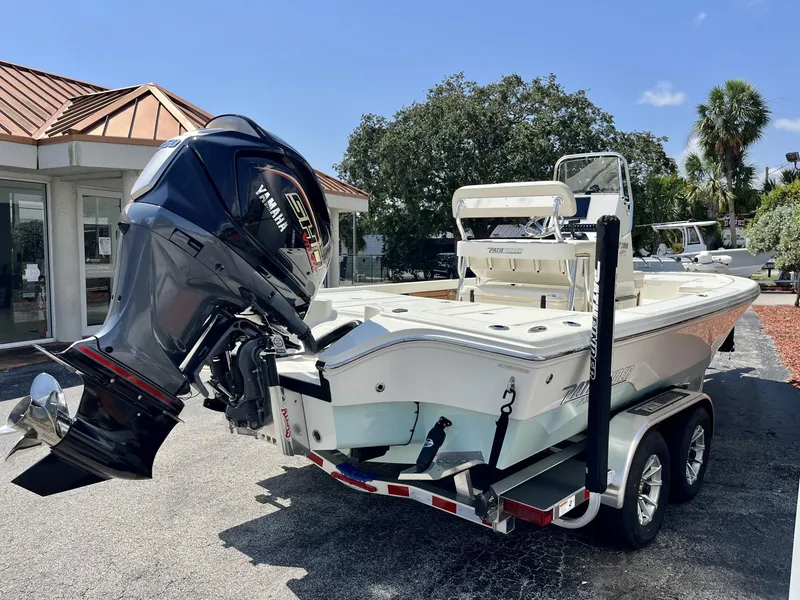 Slide: The Image of 2025 Pathfinder 2300 HPS boat with Yamaha engine on trailer, parked outdoors. - 6