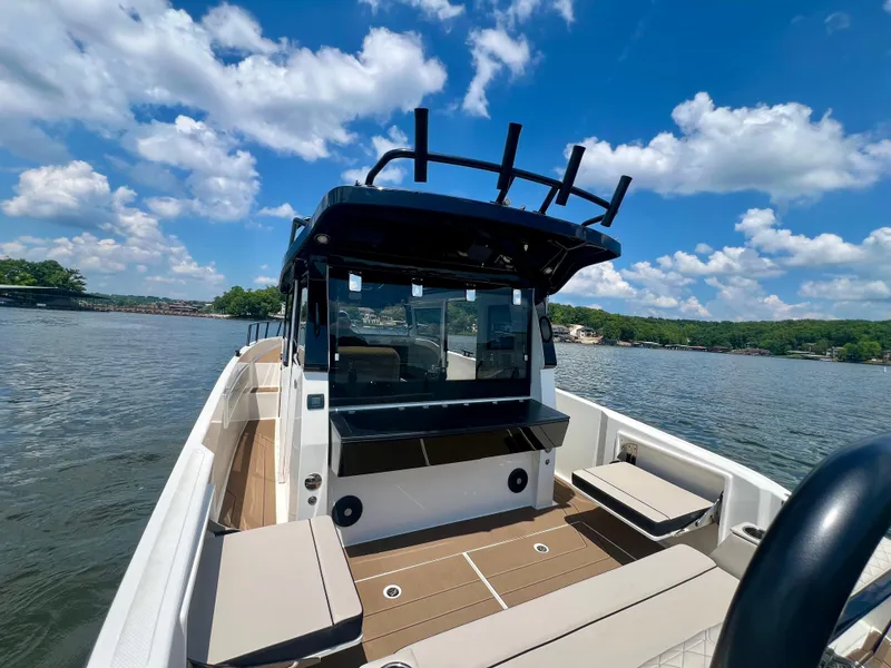 Slide: The Image of Navan C30 2025 boat on a lake under a clear blue sky. - 10