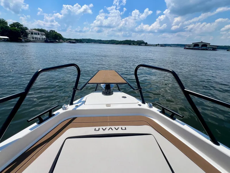 Slide: The Image of 2025 Navan C30 boat on a serene lake under a partly cloudy sky. - 18