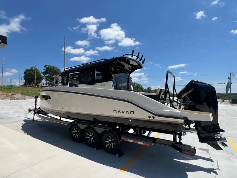 Slide: The Image of 2025 Navan C30 boat on trailer under clear blue sky. - 2