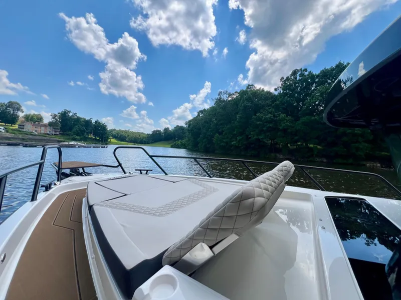 Slide: The Image of Luxurious Navan C30 boat on a serene lake under a clear blue sky. - 20