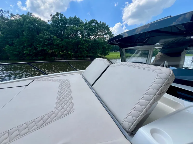 Slide: The Image of 2025 Navan C30 boat with luxurious seating, cruising on a serene lake under a blue sky. - 21