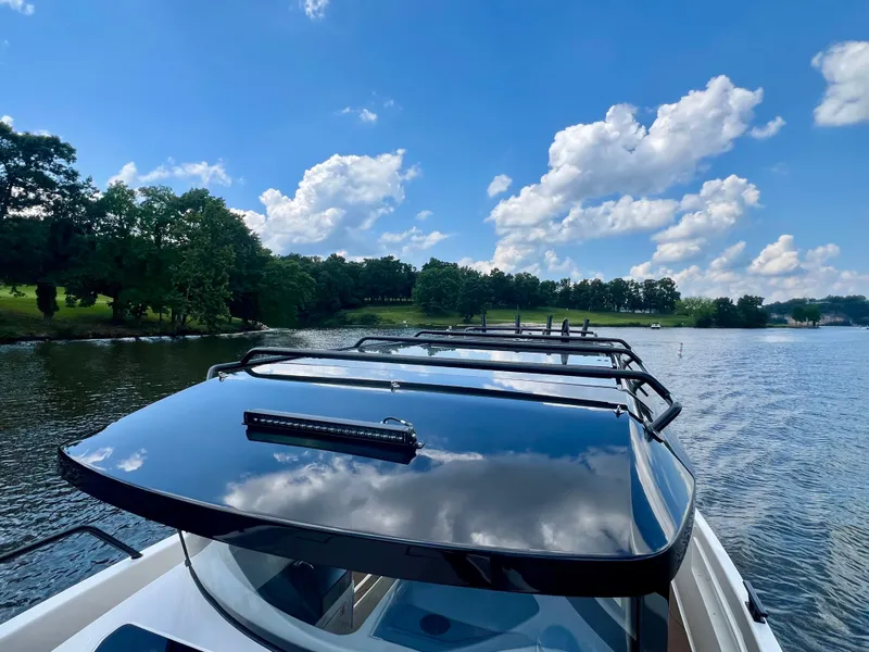 Slide: The Image of 2025 Navan C30 boat cruising on a scenic lake under a clear blue sky. - 23