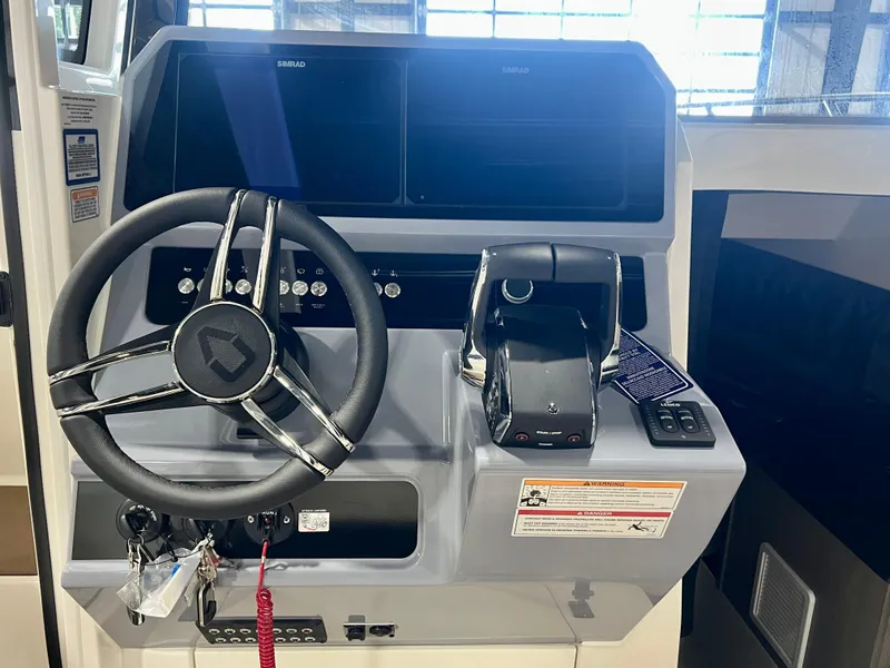 Slide: The Image of 2025 Navan C30 boat dashboard with steering wheel and control panel. - 26