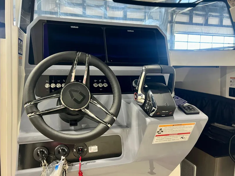 Slide: The Image of 2025 Navan C30 boat dashboard with steering wheel and control panel. - 27