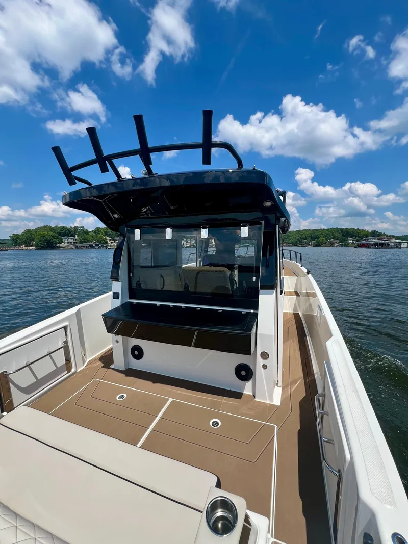 Slide: The Image of Navan C30 2025 boat on water, featuring spacious deck and modern design under a clear blue sky. - 3