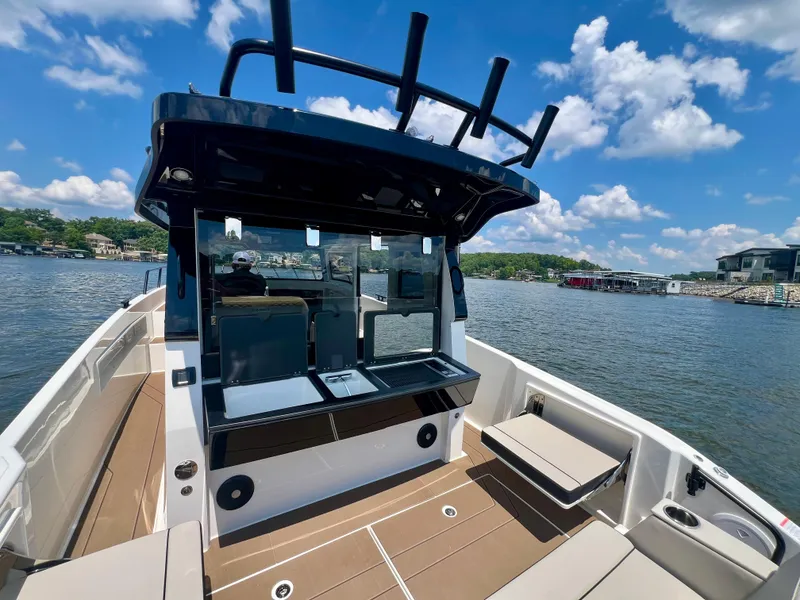 Slide: The Image of 2025 Navan C30 boat interior with seating, helm, and water view under a blue sky. - 4