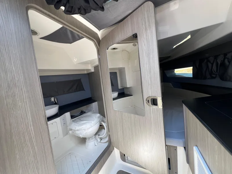 Slide: The Image of Interior of 2025 Navan C30 boat featuring modern bathroom and sleeping area. - 41