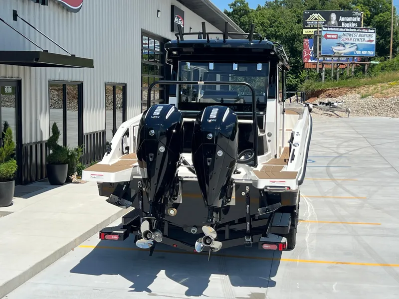 Slide: The Image of 2025 Navan C30 boat with dual outboard motors parked outside a showroom. - 45