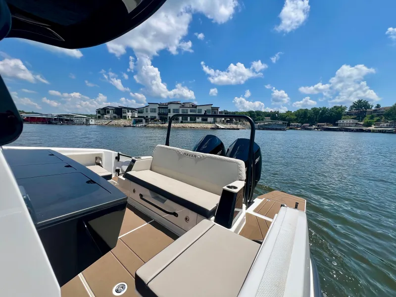 Slide: The Image of Navan C30 boat on a sunny lake, showcasing luxurious seating and dual engines. - 5