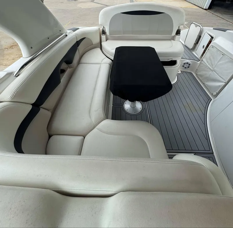 Slide: The Image of 2007 Chaparral SSX 276 boat interior with white seating and black table. - 15