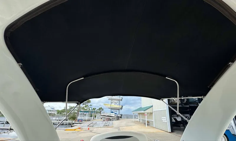Slide: The Image of 2007 Chaparral SSX 276 boat with black canopy at a marina. - 19