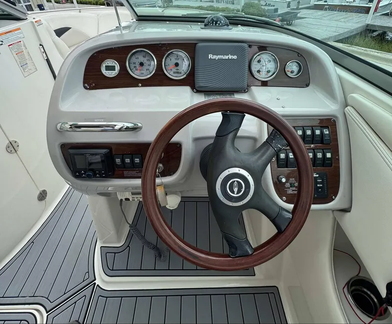Slide: The Image of Steering wheel and dashboard of 2007 Chaparral SSX 276 boat with gauges and controls. - 25
