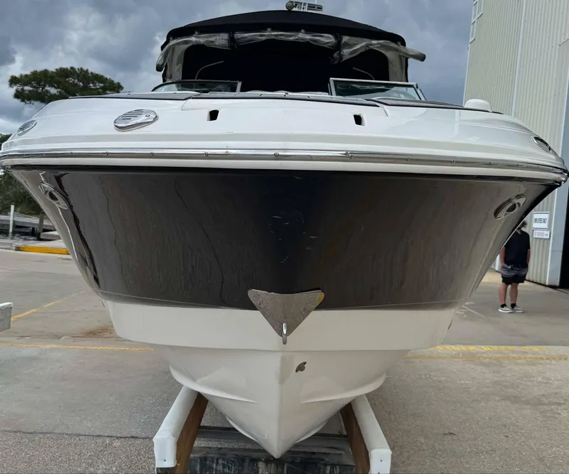 Slide: The Image of 2007 Chaparral SSX 276 boat, front view, docked outdoors under cloudy sky. - 3