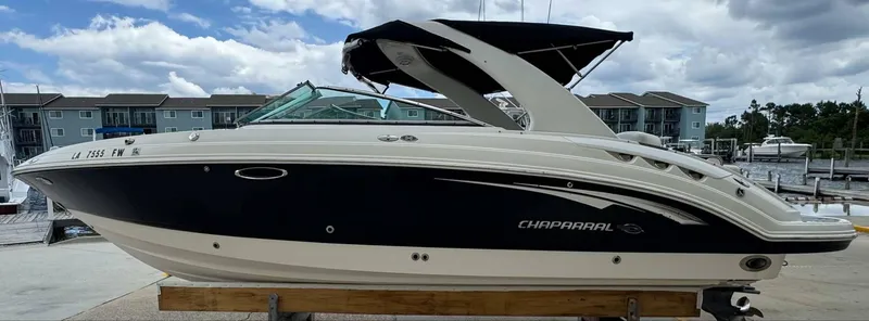 Slide: The Image of 2007 Chaparral SSX 276 boat docked, featuring sleek design and modern architecture. - 5