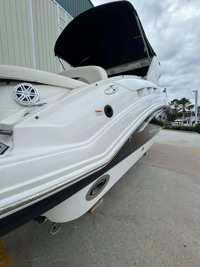 Slide: The Image of 2007 Chaparral SSX 276 boat, white exterior, docked on concrete, overcast sky. - 7