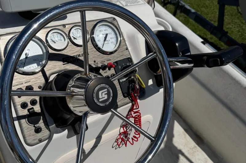 Slide: The Image of Steering wheel and dashboard of a 2016 Carolina Skiff J16 boat. - 3