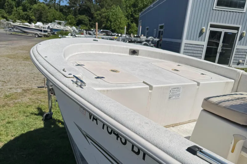 Slide: The Image of 2016 Carolina Skiff J16 boat on display outdoors near a building. - 5