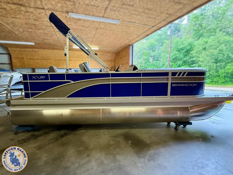 Slide: The Image of 2024 Bennington 20 SXSNP pontoon boat in a covered storage area. - 1