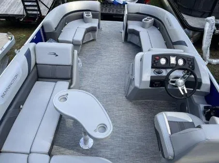 Slide: The Image of 2024 Bennington 20 SXSNP pontoon boat interior with gray seating and steering console. - 15