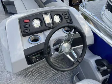 Slide: The Image of 2024 Bennington 20 SXSNP boat dashboard with steering wheel and control panel. - 16
