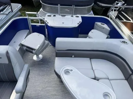 Slide: The Image of 2024 Bennington 20 SXSNP pontoon boat interior with gray seating and blue accents. - 17