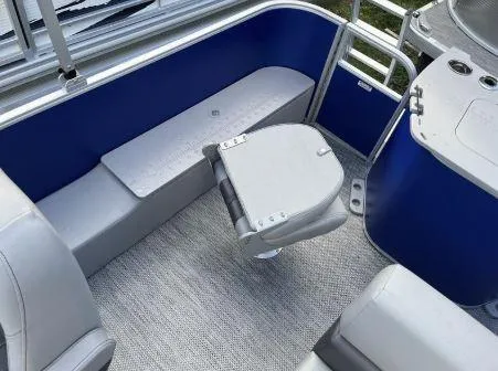 Slide: The Image of 2024 Bennington 20 SXSNP pontoon boat interior with blue and gray seating. - 18