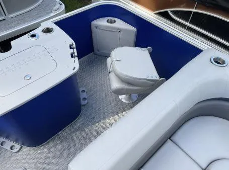 Slide: The Image of 2024 Bennington 20 SXSNP boat interior with blue accents and seating area. - 19