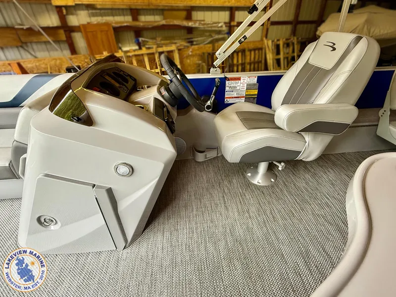 Slide: The Image of 2024 Bennington 20 SXSNP boat interior with captain's chair and steering console. - 4