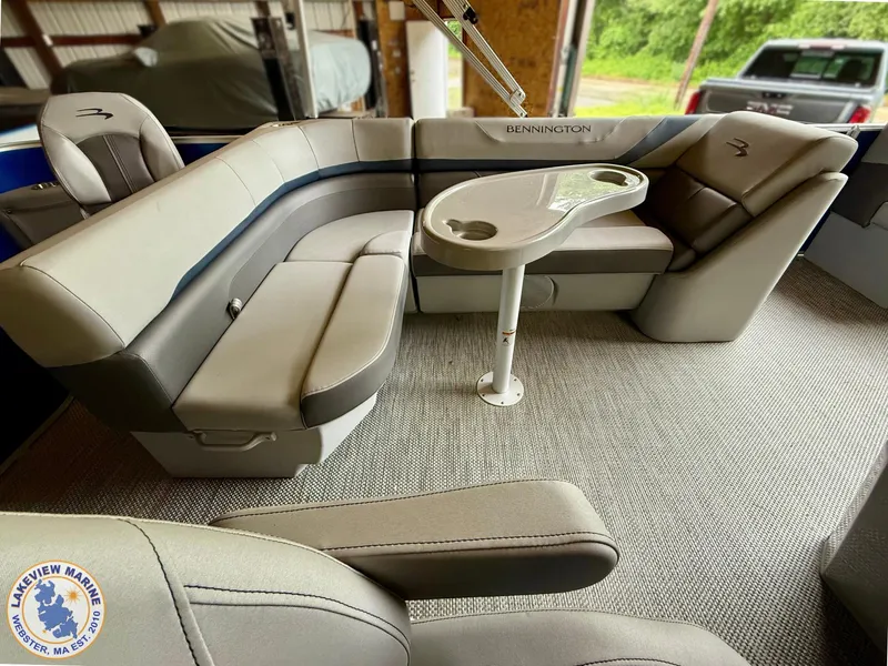 Slide: The Image of 2024 Bennington 20 SXSNP boat interior with plush seating and a sleek table. - 6
