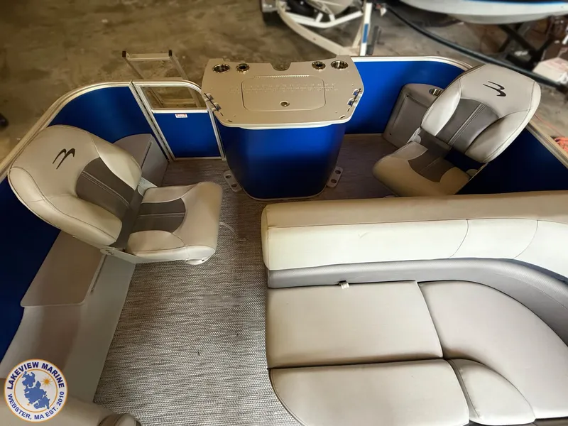 Slide: The Image of 2024 Bennington 20 SXSNP pontoon boat interior with plush seating and helm station. - 7