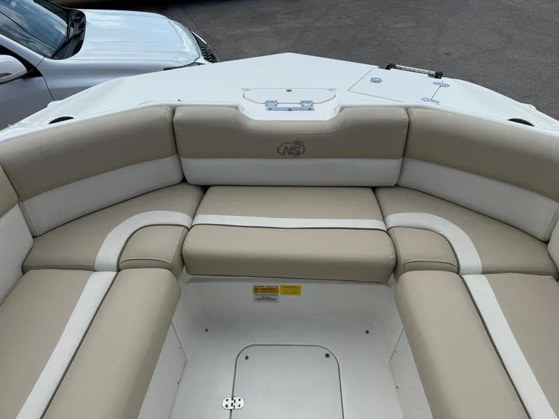 Slide: The Image of 2018 NauticStar 243DC Sport Deck boat interior with beige and white seating. - 26