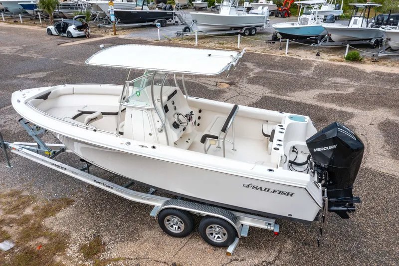 The Image of 2022 Sailfish 242CC boat on trailer, urban background, clear blue sky. - 0