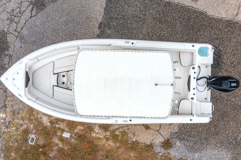 Slide: The Image of 2022 Sailfish 242CC boat on trailer under clear blue sky. - 10