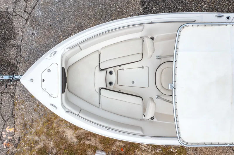 Slide: The Image of 2022 Sailfish 242CC boat on trailer with Mercury engine, parked near a hotel. - 11