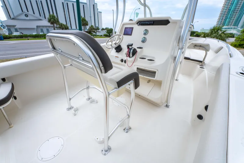 Slide: The Image of 2022 Sailfish 242CC boat console with steering wheel and navigation controls. - 15