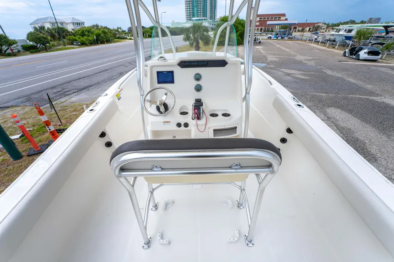 Slide: The Image of 2022 Sailfish 242CC boat dashboard with compass, controls, and Simrad display. - 16