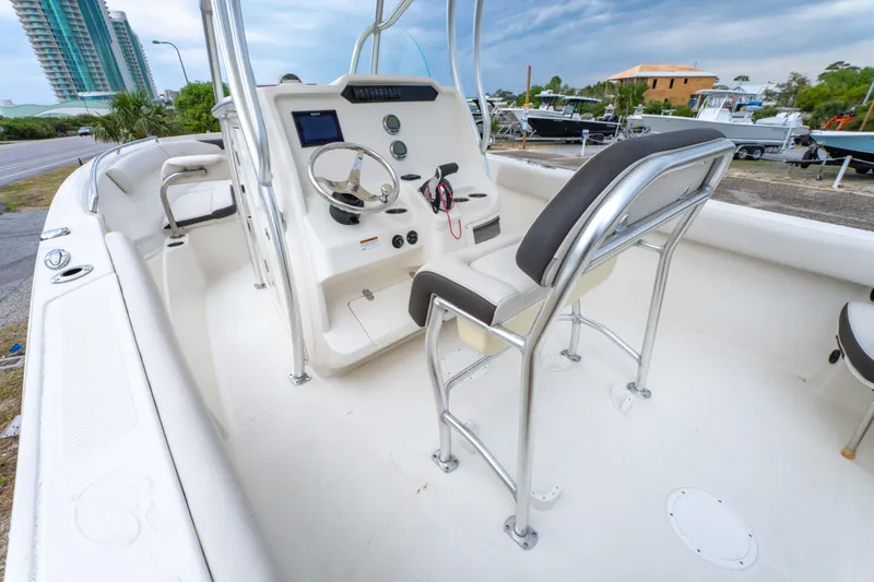Slide: The Image of 2022 Sailfish 242CC boat dashboard with steering wheel and control panel. - 17