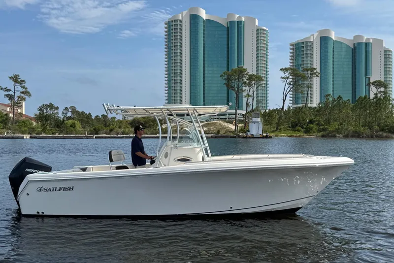 Slide: The Image of 2022 Sailfish 242CC boat on trailer, urban background, sunny day. - 2