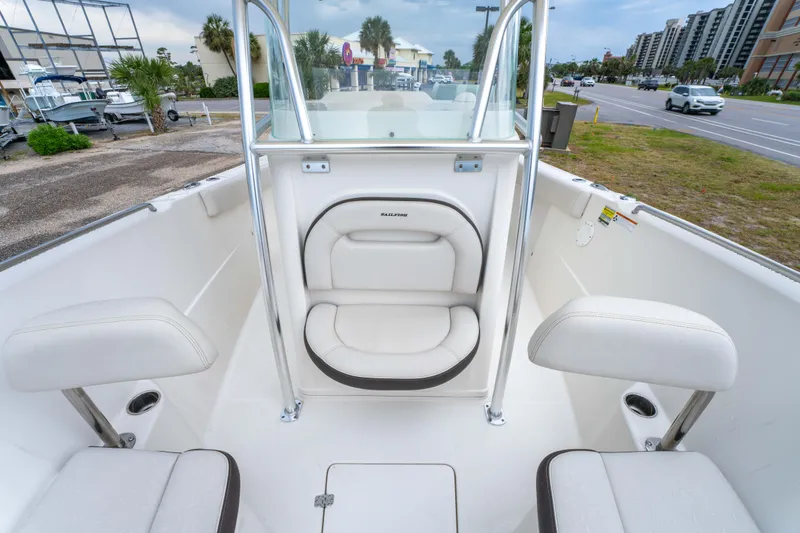 Slide: The Image of 2022 Sailfish 242CC boat interior with cushioned seating and storage compartments. - 23