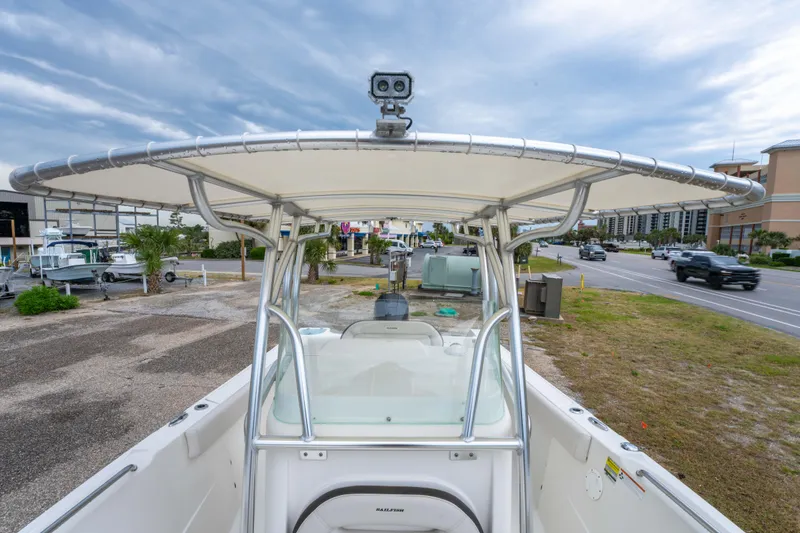 Slide: The Image of 2022 Sailfish 242CC boat interior with steering console and seating area. - 24