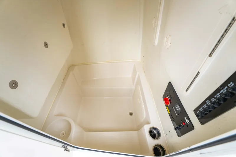 Slide: The Image of 2022 Sailfish 242CC boat interior with seating, steering wheel, and Mercury engine. - 27