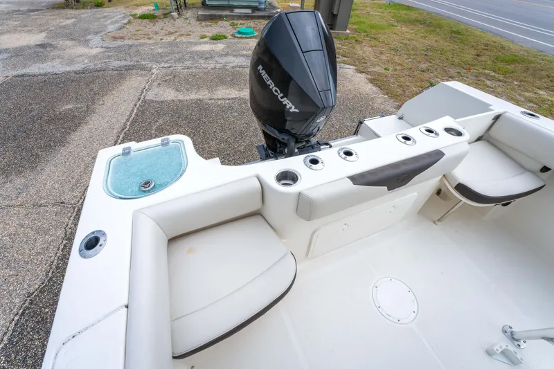 Slide: The Image of 2022 Sailfish 242CC boat interior with Mercury engine, featuring seating and storage compartments. - 38