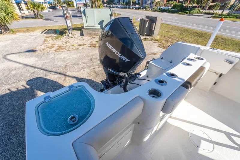 Slide: The Image of 2022 Sailfish 242CC boat with Mercury engine, featuring rod holders and livewell. - 39