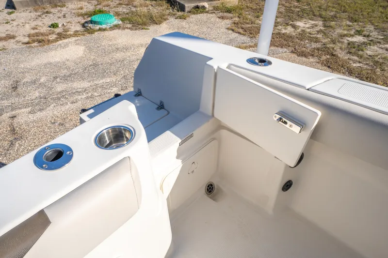 Slide: The Image of 2022 Sailfish 242CC boat interior with cup holders and storage compartments. - 41
