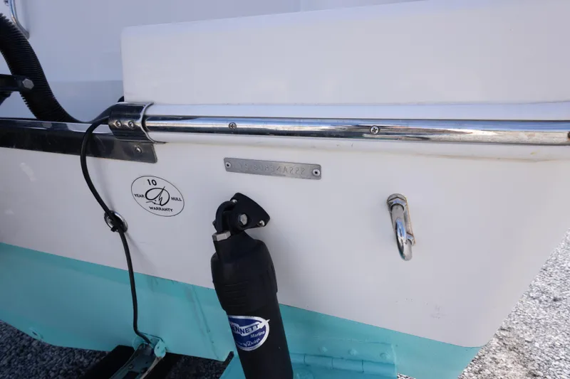Slide: The Image of 2022 Sailfish 242 CC boat stern with warranty sticker and Bennett Marine trim tab. - 44