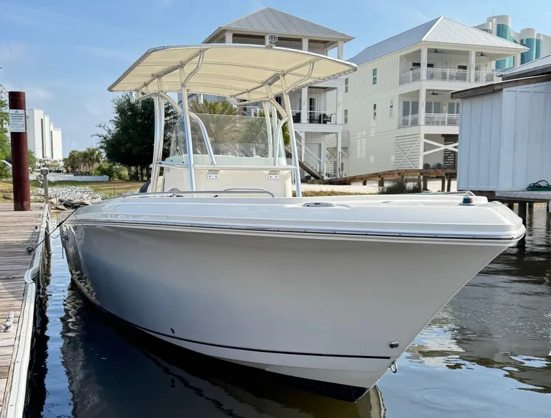 Slide: The Image of 2022 Sailfish 242CC boat on trailer, featuring Mercury outboard engine, parked near road. - 5