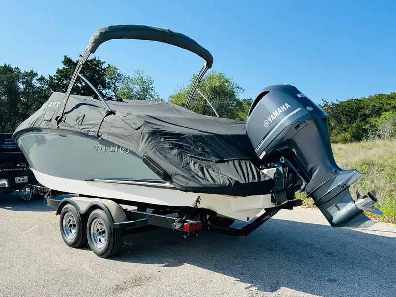 Slide: The Image of 2018 Cobalt 23SC boat with Yamaha engine on trailer, covered and parked outdoors. - 12