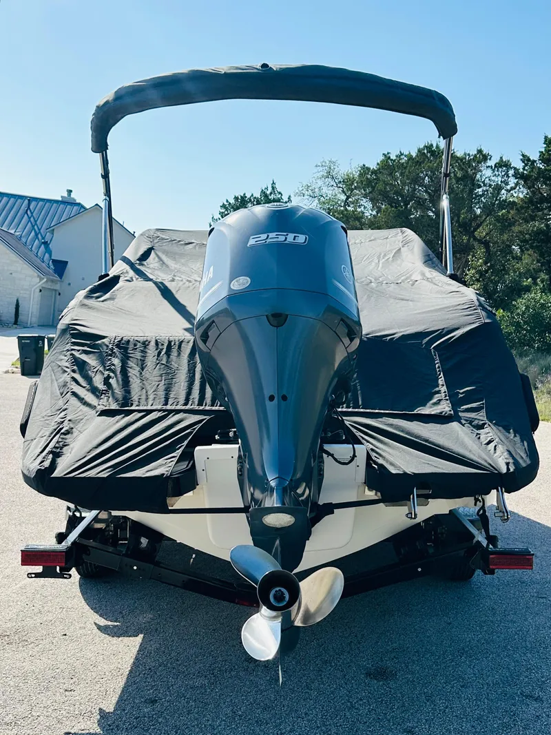 Slide: The Image of 2018 Cobalt 23SC boat with cover and outboard motor in driveway. - 13