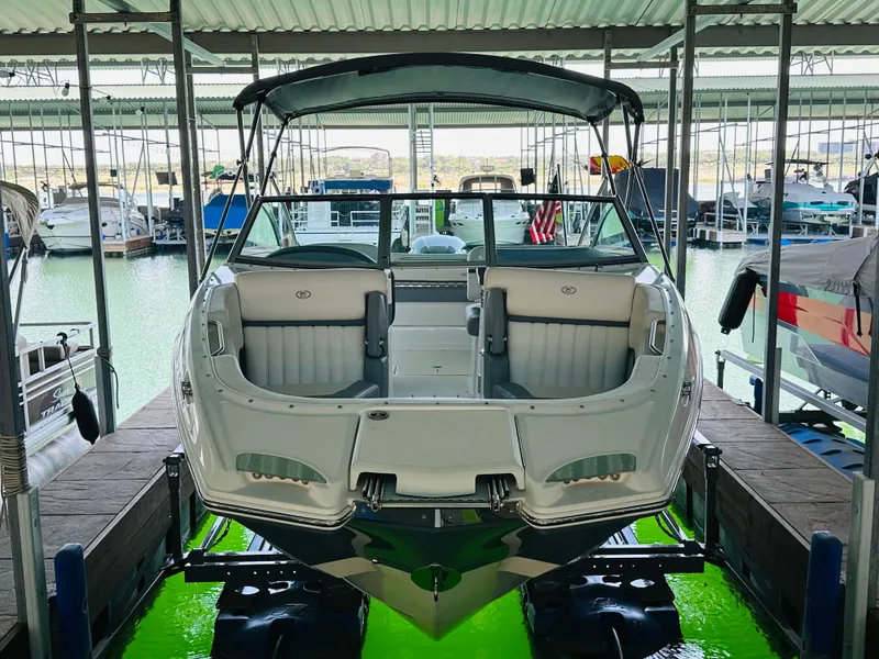 Slide: The Image of 2018 Cobalt 23SC boat docked in a marina, front view. - 19